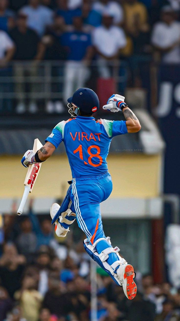Batter leaping in celebration after reaching a century